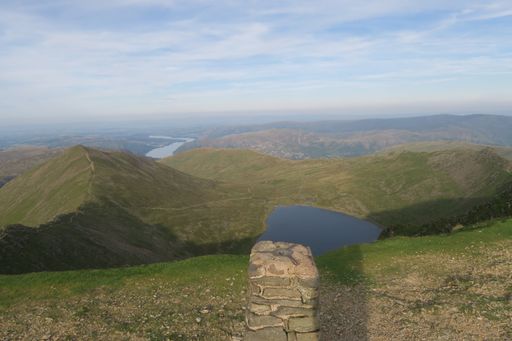The view from Helvellyn mountain with beautiful lakes and hills in the background during daytime