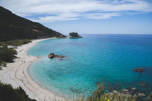 A landscape shot of the beautiful Potami Beach under the blue cloudy sky in Greece