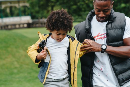 An African-American child and his father in the park