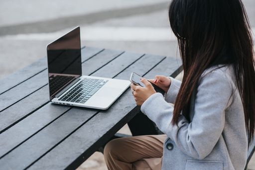 A young Caucasian woman working with a notebook in the cafe