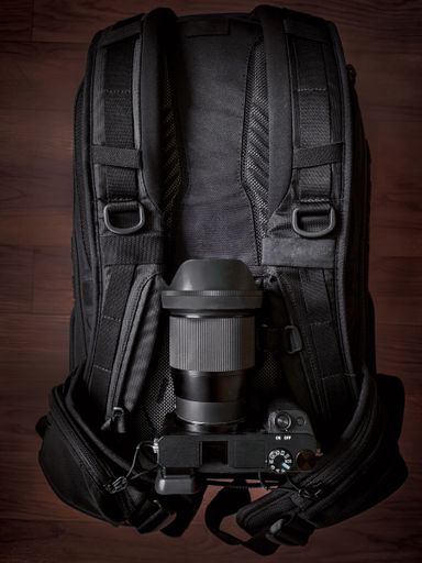 A top view of a professional camera on a backpack on the floor