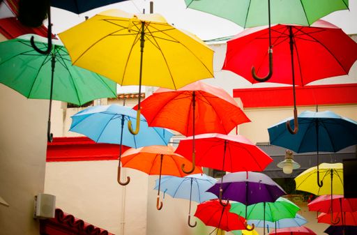 The colorful hanging umbrellas on the street.