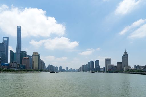 The Huangpu River with city buildings against the background of the blue sky. Shanghai, China.