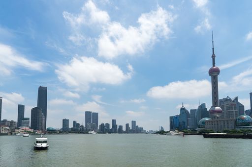 The Huangpu River with city buildings against the background of the blue sky. Shanghai, China.