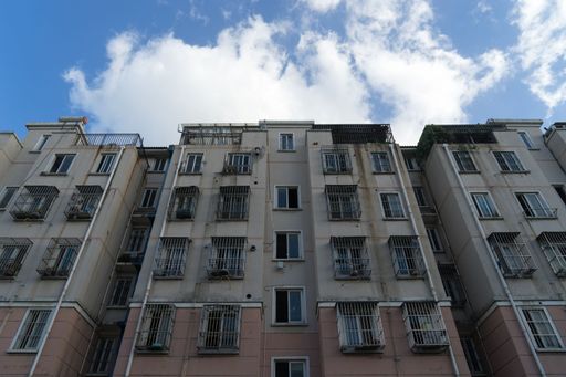 A low-angle shot of the building's facade against the background of the blue sky.