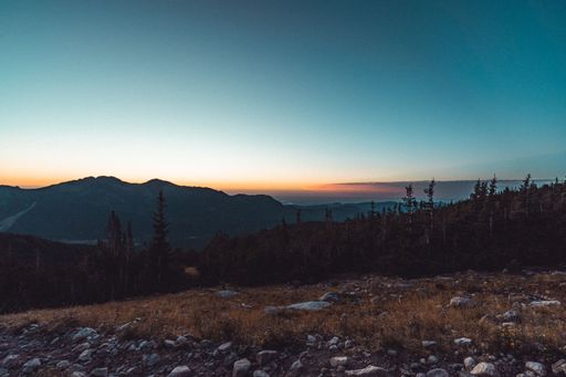 A beautiful aerial view of an orange sunset over mountains up in the hills
