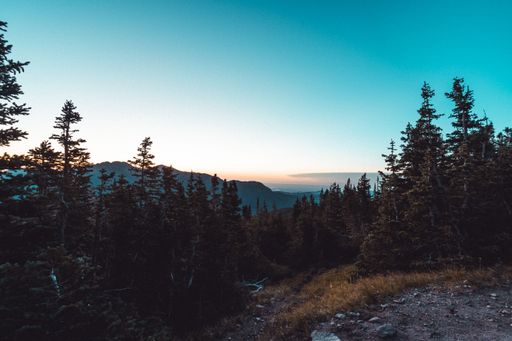 A beautiful aerial view of a sunset over mountains up in the hills with blue sky background