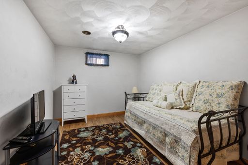 A beautiful simple house room interior with a large sofa bed and and a white cabinet
