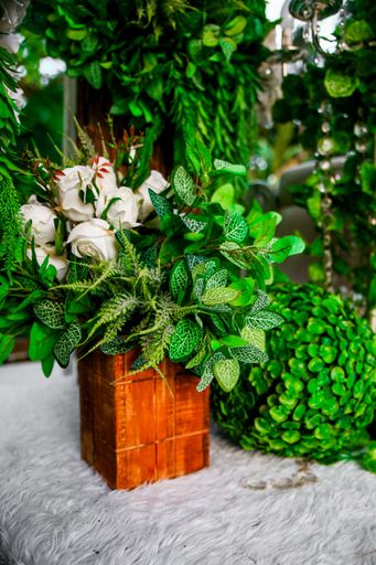 A vertical shot of a beautiful bouquet of white roses with bright green leaves for wedding decorations