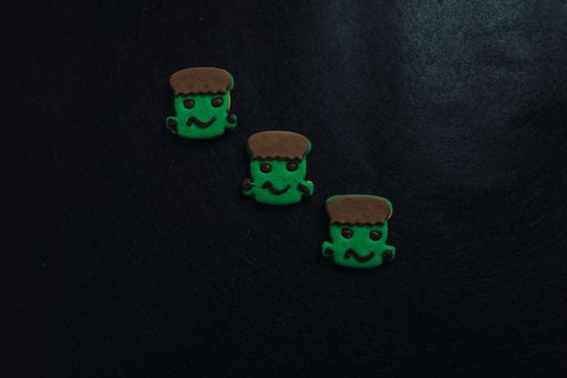 A closeup of Halloween cookies in black background