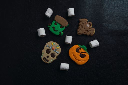 A closeup of Halloween cookies in black background