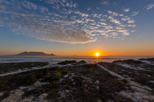 A beautiful shot of the sunset over the shore of the famous Table mountain in Cape Town, South Africa