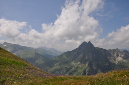 A Beautiful landscape of green valleys and rocky hills under blue cloudy sky