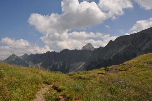A Beautiful landscape of green valleys and rocky hills under blue cloudy sky