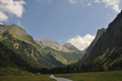 A Beautiful landscape of green valleys and rocky hills under blue cloudy sky