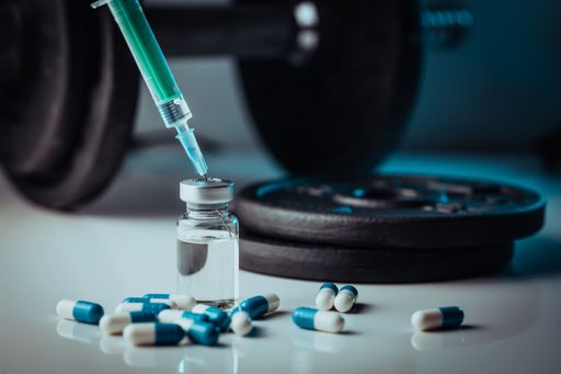 A pharmaceutical syringe with needle and medical pills - illegal doping drugs in sport