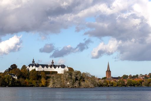 Plon, Germany, Ploen lake, dramatic clouds fly over the lake in background Ploen castle, skyline