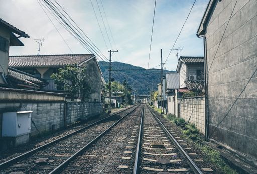 A scenic view of an empty railroad between houses in Japan