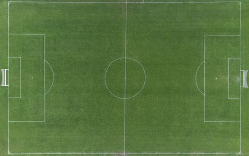 A top view of a green soccer field in Denmark