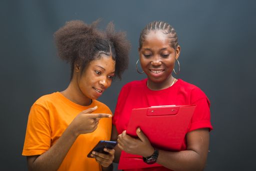 A closeup shot of young African ladies using their smartphones