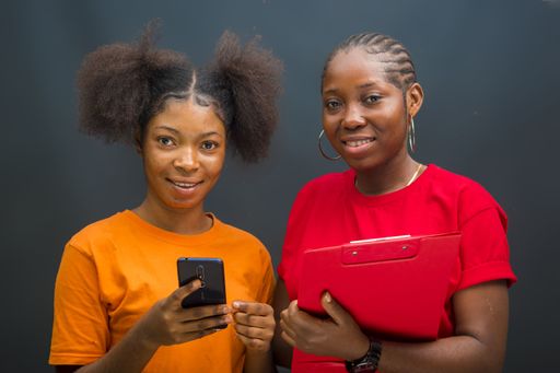 A closeup shot of young African ladies using their smartphones