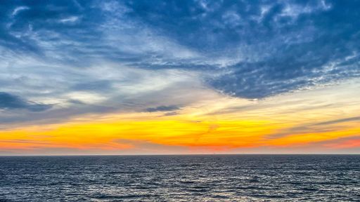 An image of a water surface with a beautiful sky during golden hour