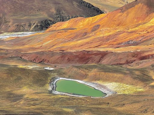 A scenic landscape of a little lake in the mountains of Shangri-La