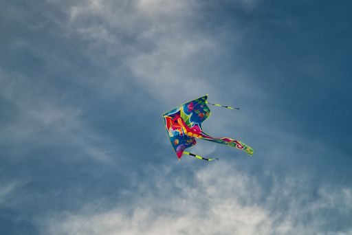 A closeup of a kite flying in the sky during daytime