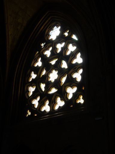 A vertical shot of a stained glass window in the church of Getaria, Spain