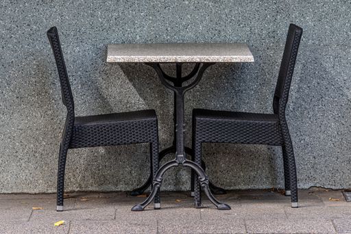 An empty table with two chairs in an outdoors cafe