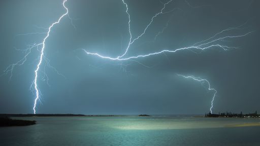 A magical view of a striking lightning over a sea location in a stormy day