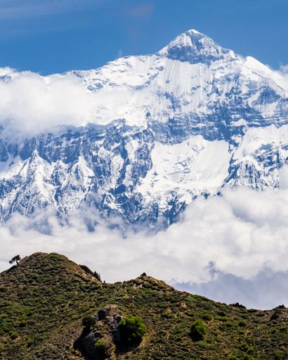 A vertical shot of Annapurna and Nilgiri mountains in the Kingdom of Mustang depicting the blue view