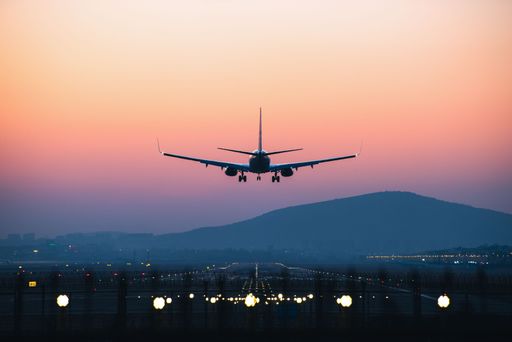 An airplane departing from airport during sunset