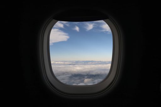 A beautiful shot of the cloudy bright sky taken from a porthole