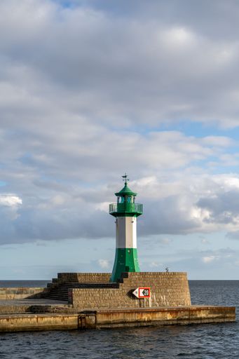 A vertical shot of the green and white Sassnitz lighthouse at the coast of the island of Rugen in Germany