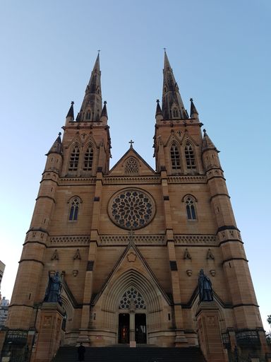 A vertical shot of St Mary's Cathedral in Sydney with a clear sky in the background.