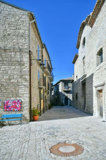 A narrow street between the old stone houses of Oratino, a medieval village in the Molise region of Italy.