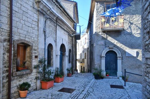 A narrow street between the old stone houses of Oratino, a medieval village in the Molise region of Italy.