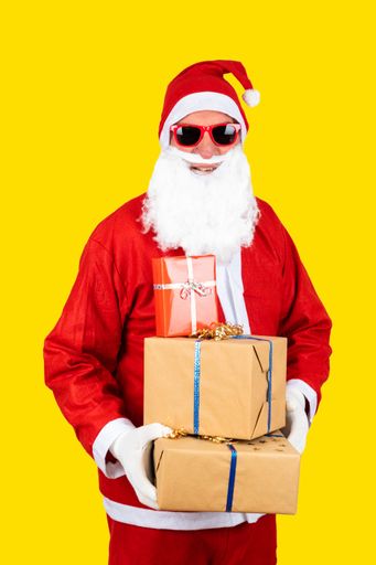 A Santa Claus with sunglasses and hat on yellow background