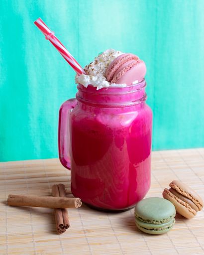 A vertical closeup shot of a delicious milkshake with pastry